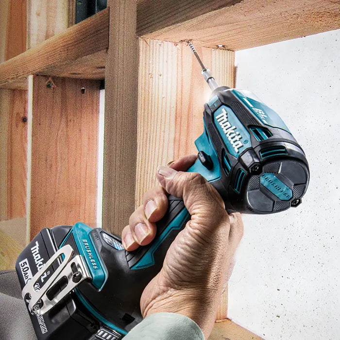 Person using a Makita impact driver on wooden construction