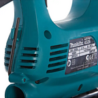 Close-up of a Makita cordless tool body in teal with a black product information label showing model 4326 and technical specs.