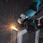 Person using a Makita angle grinder with sparks flying, wearing a black glove.