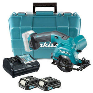 Makita cordless circular saw with teal and gray body, shown with a matching teal carrying case, two battery packs, and a black charger on a white background.