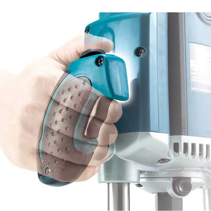 A close-up of a hand holding a teal and gray handheld attachment to a Makita Wood Router Machine, with the attachment featuring a textured brown grip and clear protective cover.