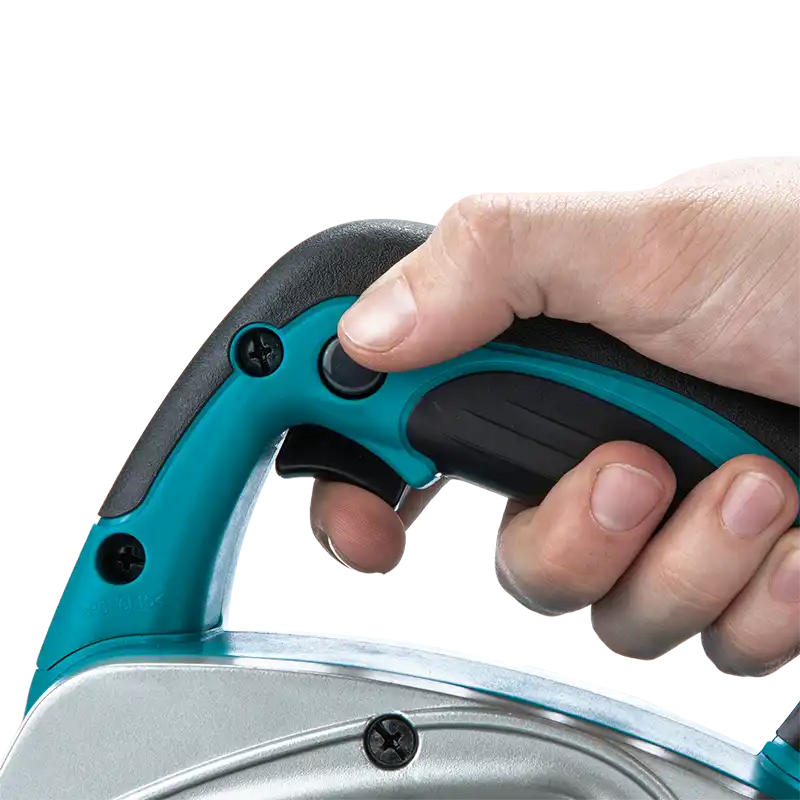 A close-up of a person's hand pressing a button on the handle of a teal and black thickness planer against a white background.