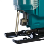 Close-up of a teal and black electric jigsaw saw with a clear dust collector and metal guide bar, shown against a white background.