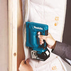 Person using a Makita Cordless Nailing Tool
