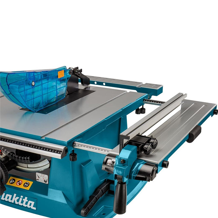 A Makita table saw with a teal blue body, silver metal table surface, and a translucent blue safety guard, shown on a clean white background.