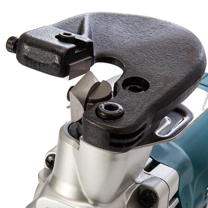 Close-up of Makita Metal Shearing Machine attachment with a textured black metal guard and silver metal body, showing the cutting wheel and mounting hardware against a white background.