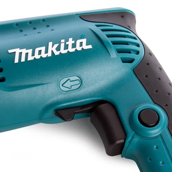 Close-up of a Makita cordless drill or driver showing the teal plastic body, white Makita logo, black trigger, and textured black grip on a white background.
