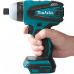 Hand holding a Makita cordless drill on a white background