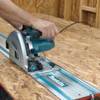 Person using a Makita Guide Rail for saw on wood