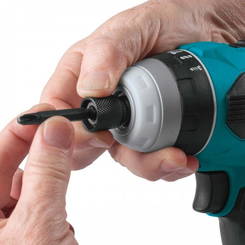 Hand holding a cordless drill with a black drill bit on a white background