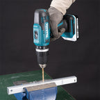 Person using a Makita drill on a piece of aluminium rode wearing gloves