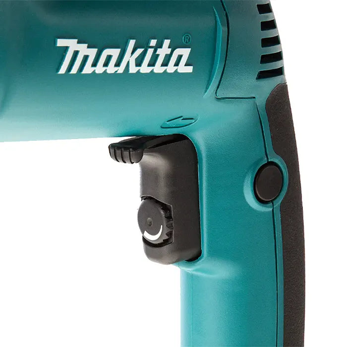 Close-up of a Makita power tool showing the teal body, white Makita logo, black trigger switch, and side button on a white background.