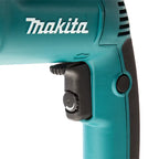 Close-up of a Makita power tool showing the teal body, white Makita logo, black trigger switch, and side button on a white background.